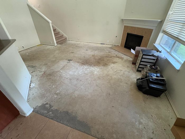 Before: living room with the old floor torn out