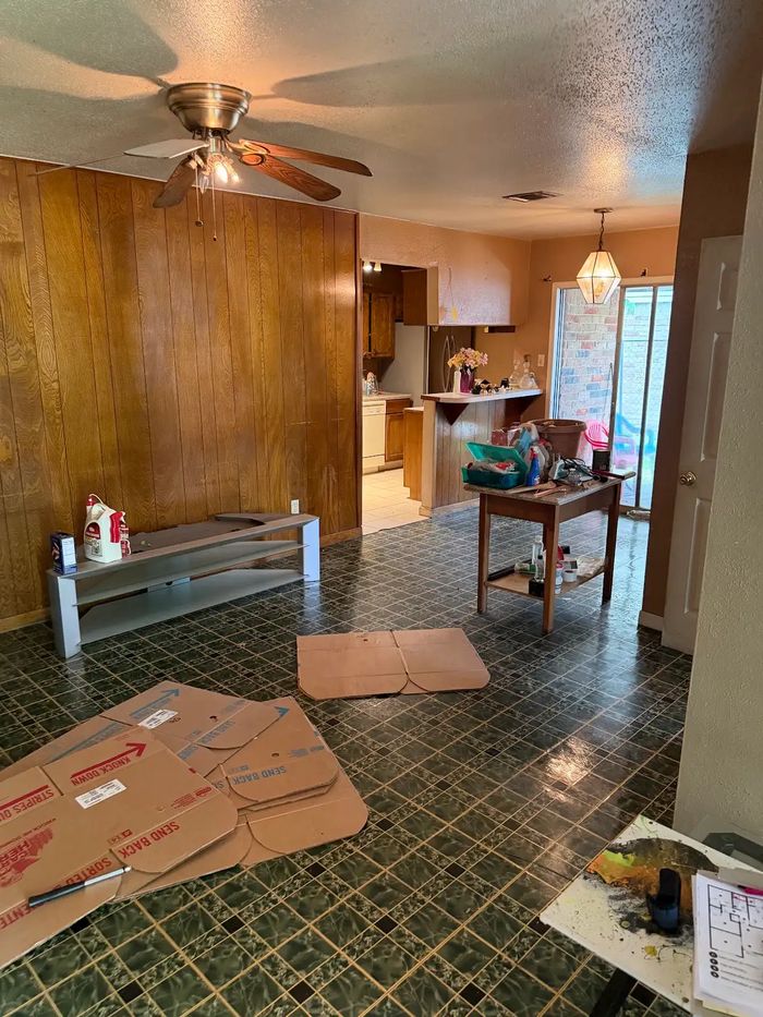 Before: living room with dark wood paneling