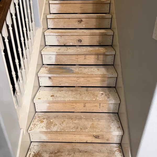 Before purchase: bare, stained stair treads with the carpet pulled up